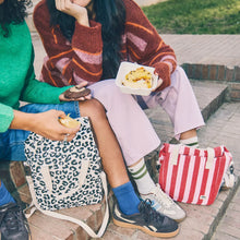 Load image into Gallery viewer, Model carrying bag crossbody (use ROKA brand lifestyle shots)