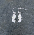Delicate silver feather drop earring on slate - ORA Gallery