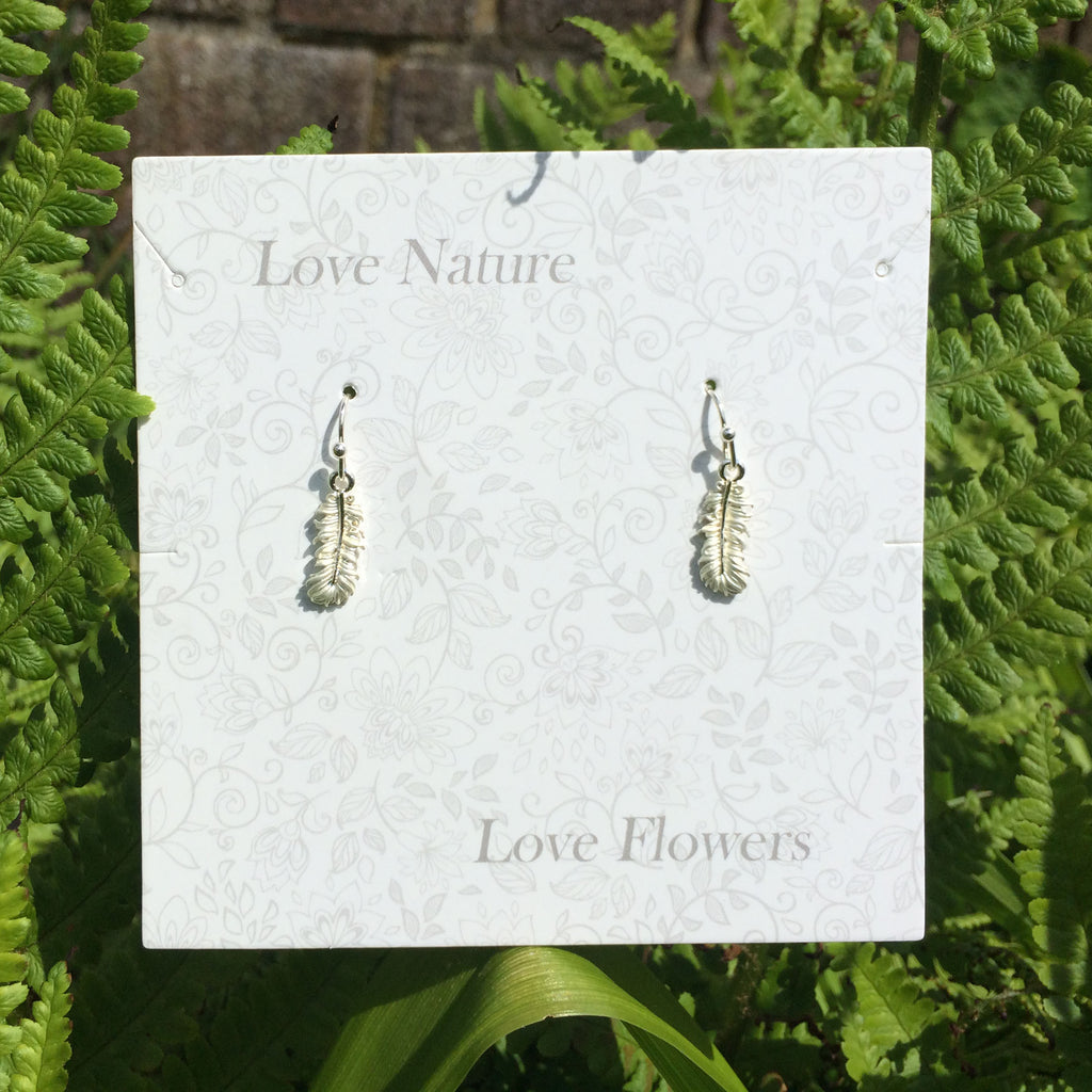 Delicate silver feather earring on presentation card - ORA Gallery