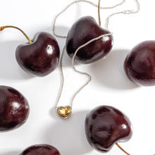 Load image into Gallery viewer, Kit Heath Heart of Gold necklace and stud earrings styled with cherries — two-tone sterling silver and 18ct gold plate heart pendant on fine trace chain

