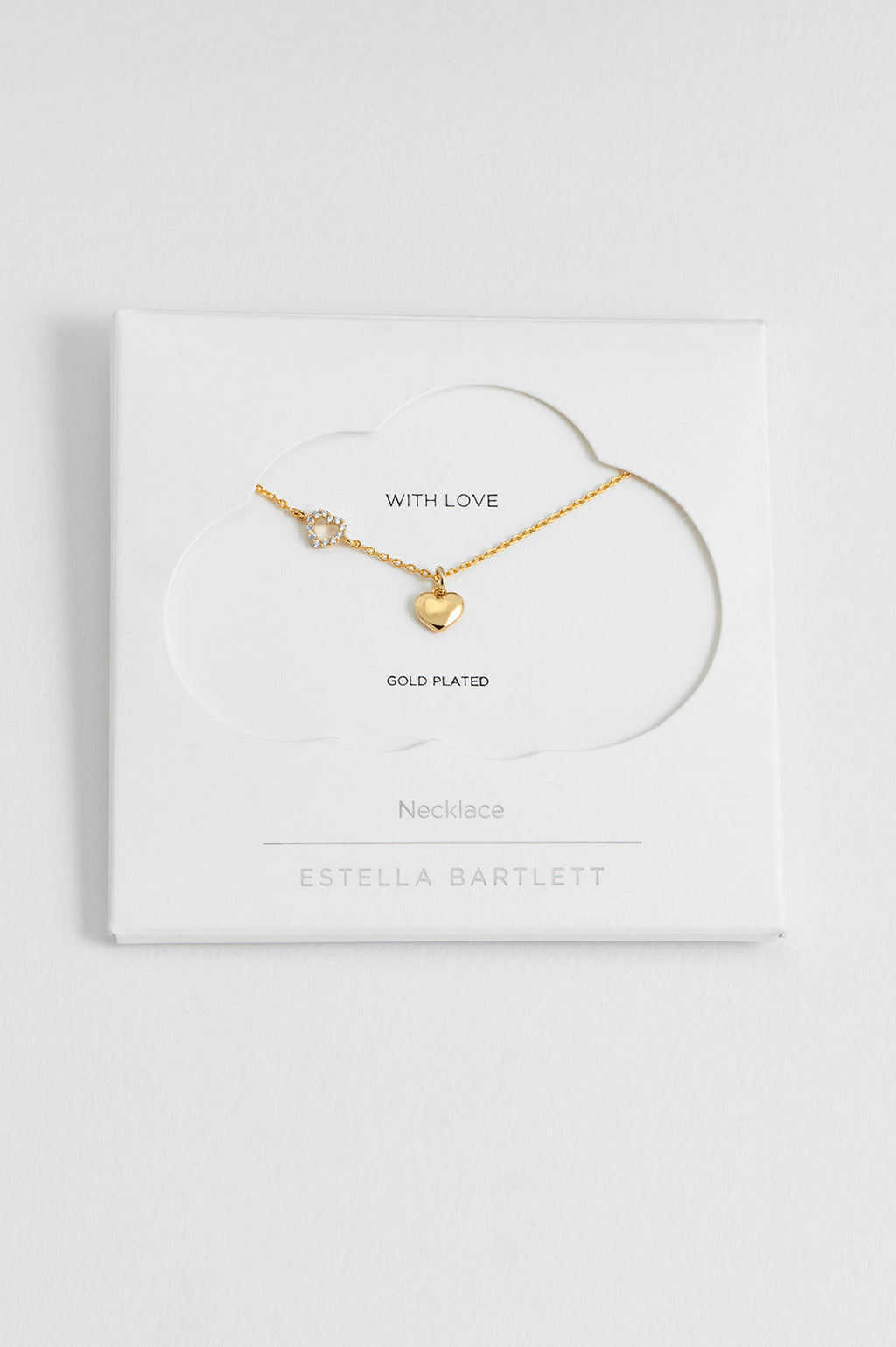 Estella Bartlett Heart Charm With Open CZ Heart Necklace in gold plate, laid flat showing the off-centre heart charm with CZ detailing