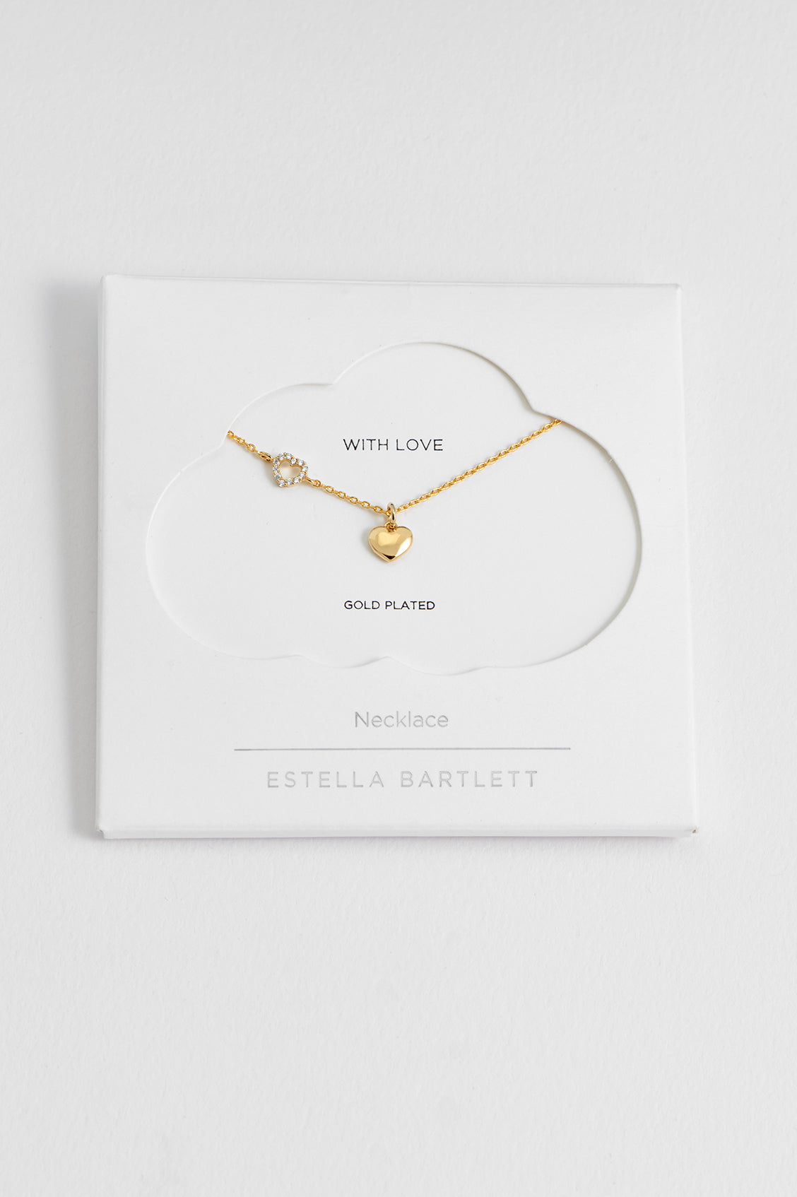 Estella Bartlett Heart Charm With Open CZ Heart Necklace in gold plate, laid flat showing the off-centre heart charm with CZ detailing