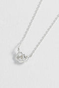 Silver necklace with a heart-shaped pendant on a white background