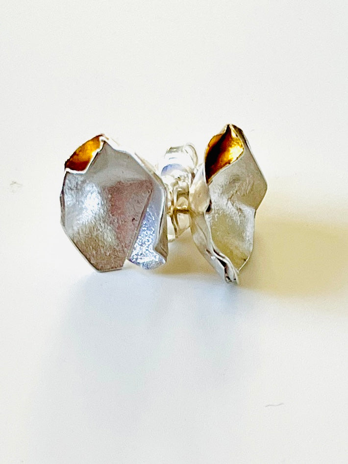 “Handmade silver hook earrings with textured gold-plated detail by Jennie Gill”