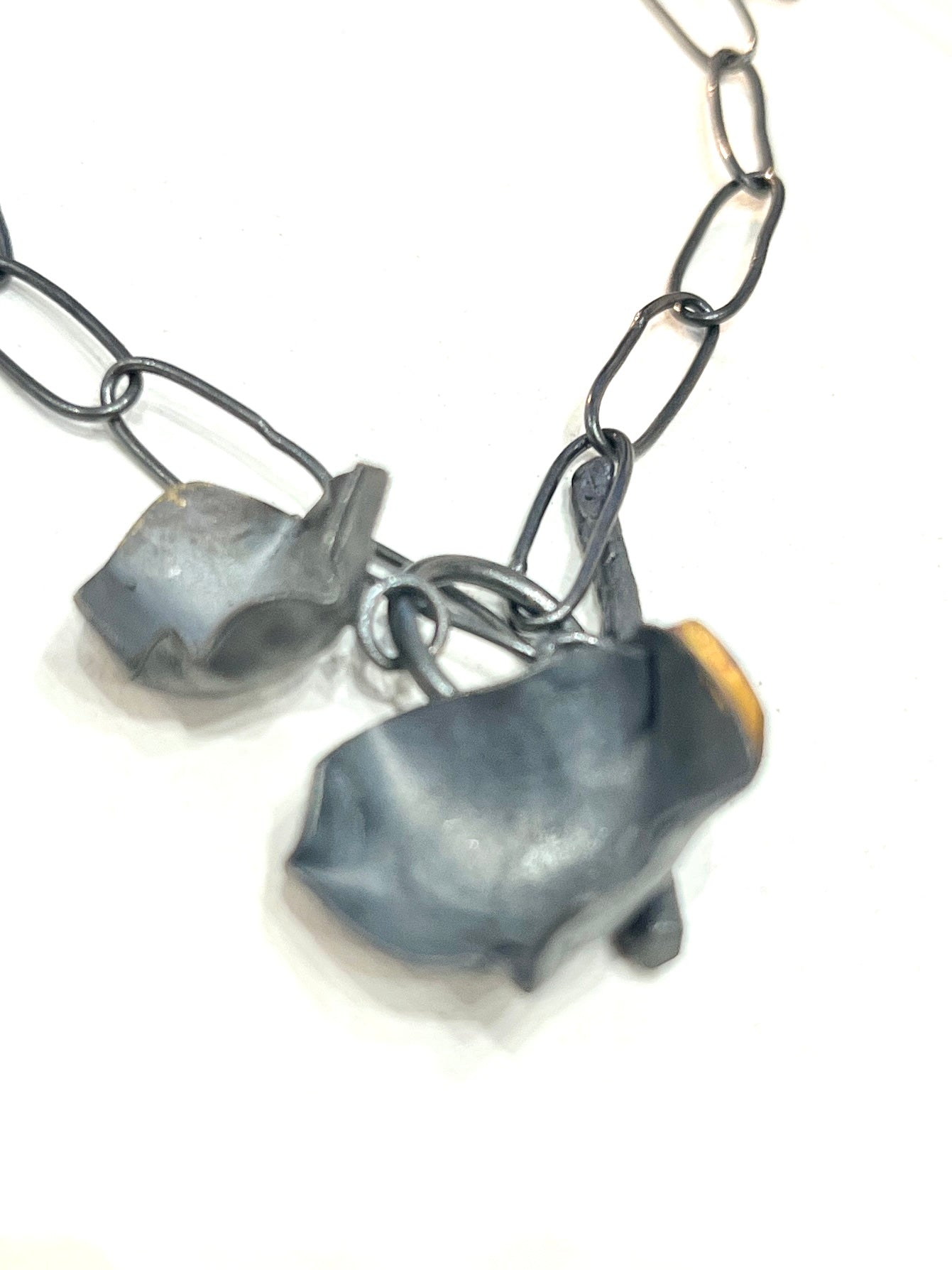 Contemporary artisan necklace in oxidised silver with gold detailing