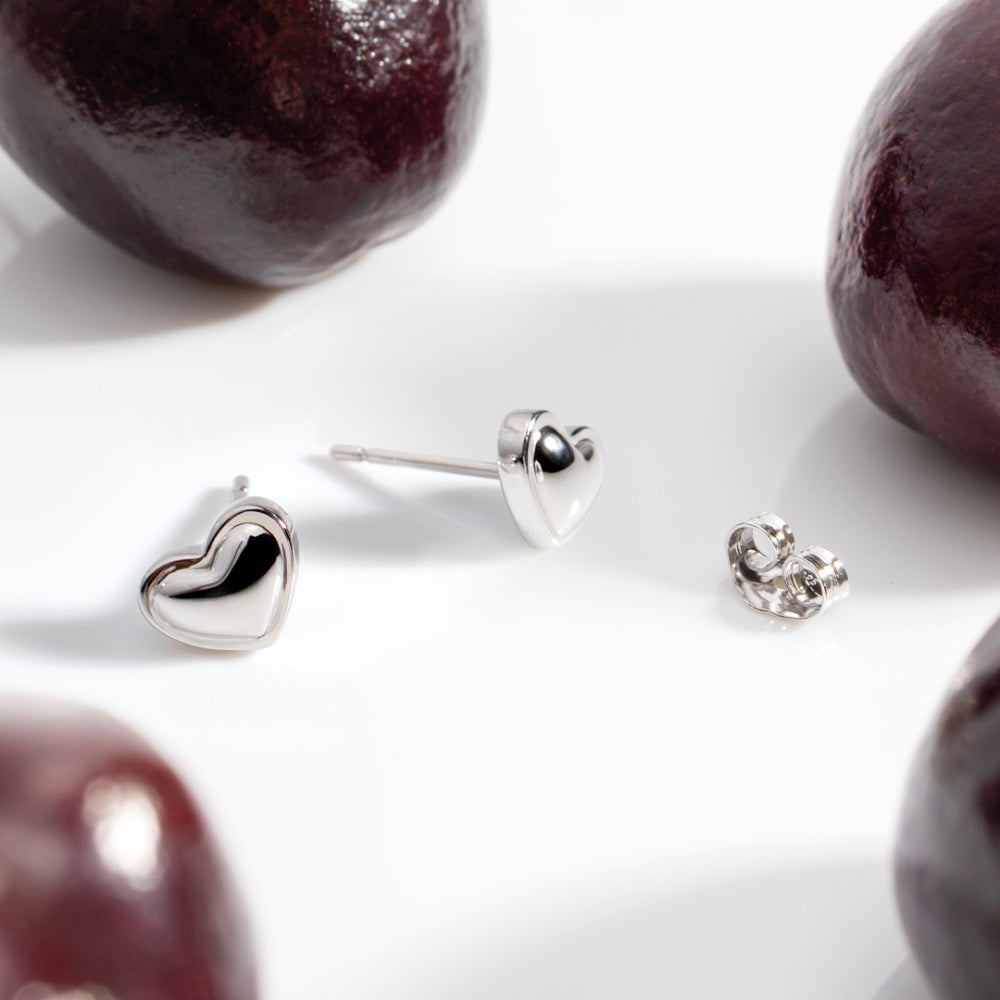   Kit Heath Heart of Gold Stud Earrings — polished rhodium-plated sterling silver sculpted mini heart stud earrings, butterfly back fitting