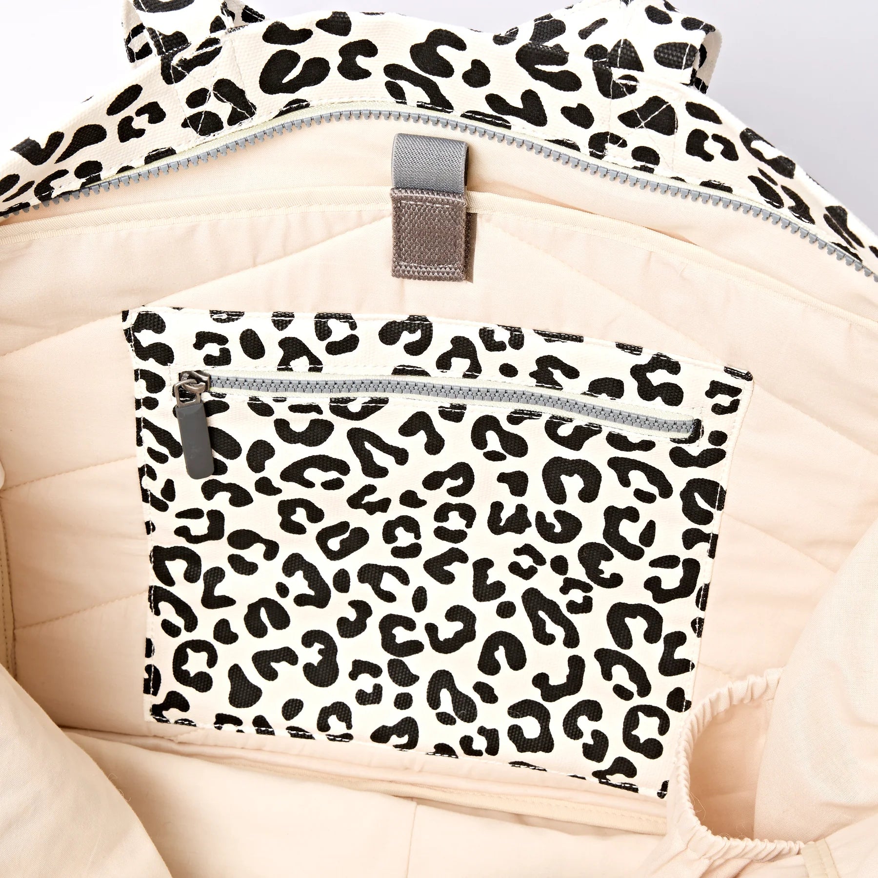Interior — laptop sleeve, zip pockets, bottle holder