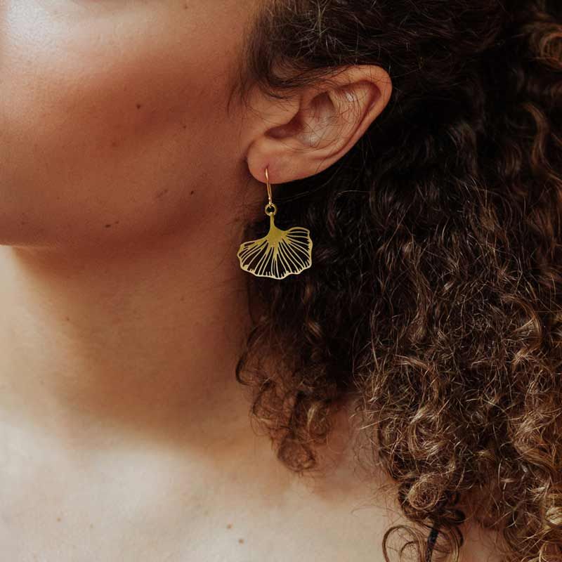 Model wearing the RAS Ginkgo Biloba single leaf gold plated earrings